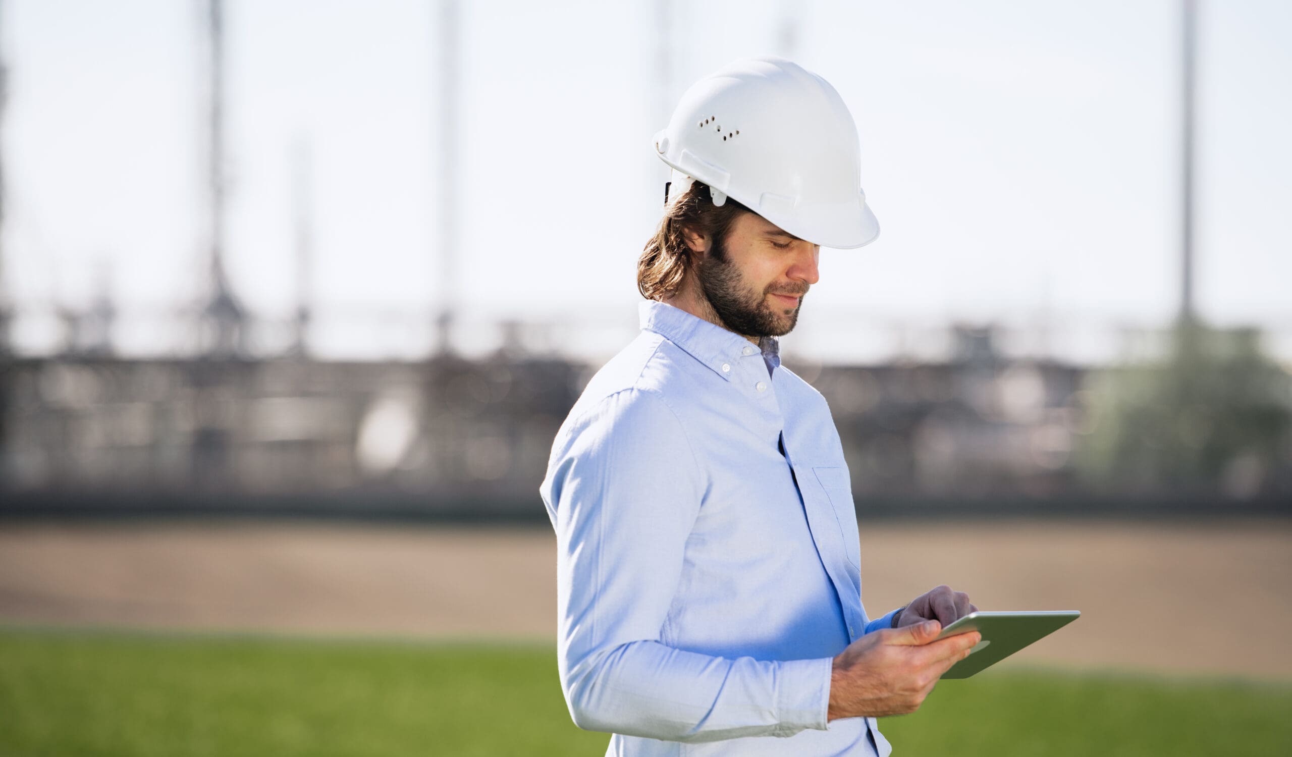 Engineer with hard hat using tablet.