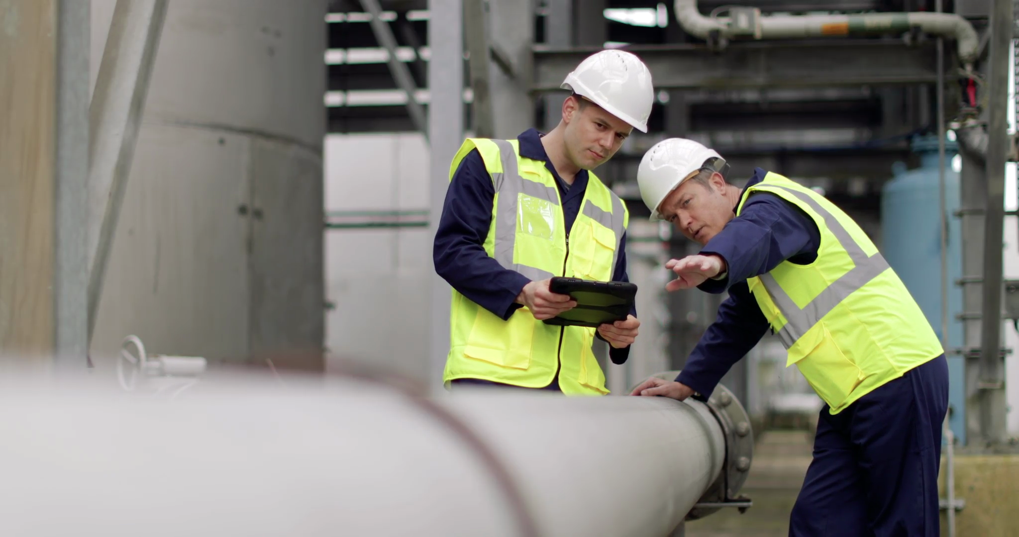 Industrial workers using a digital tablet on site