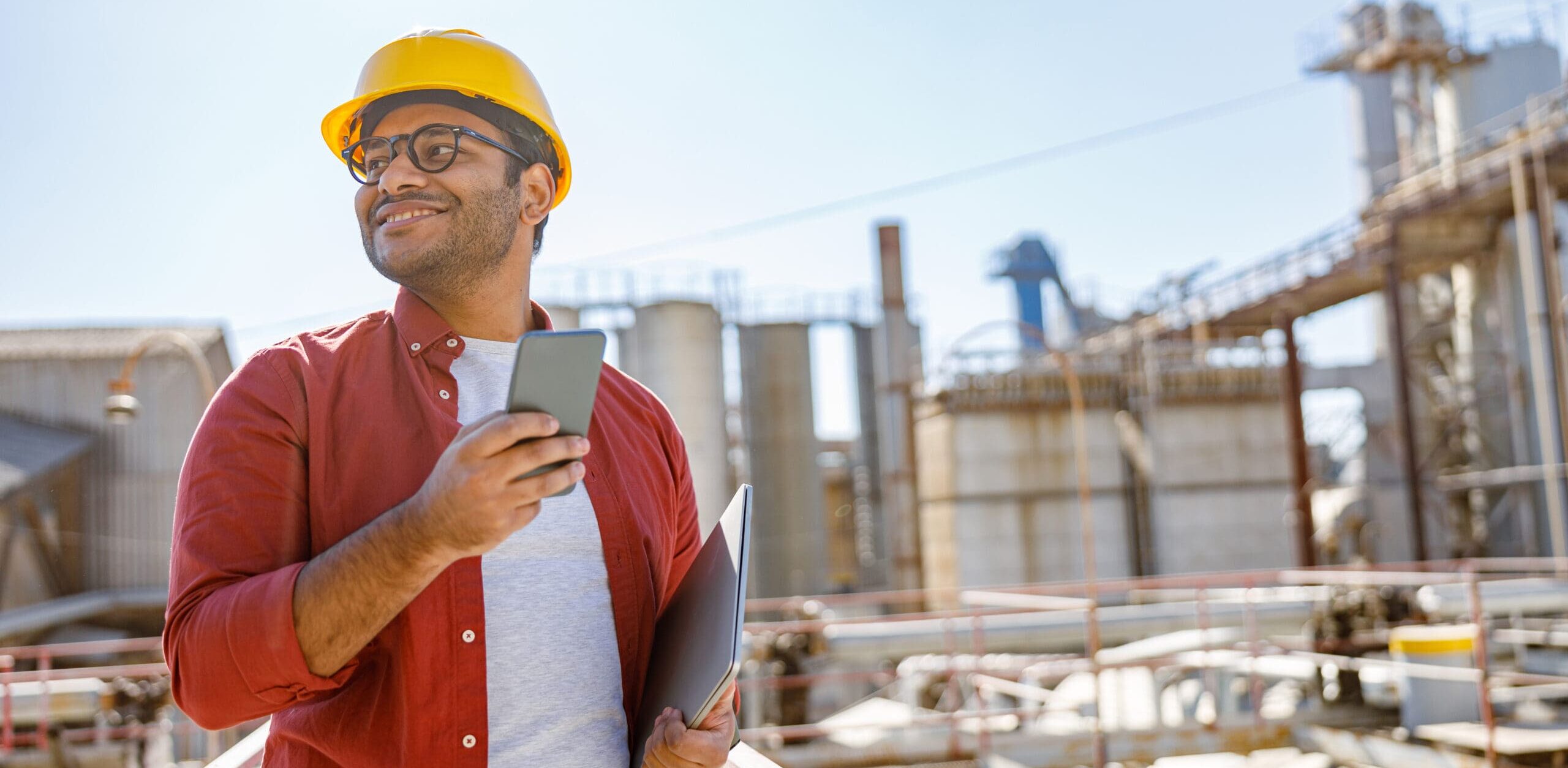 Engineer at site checking phone