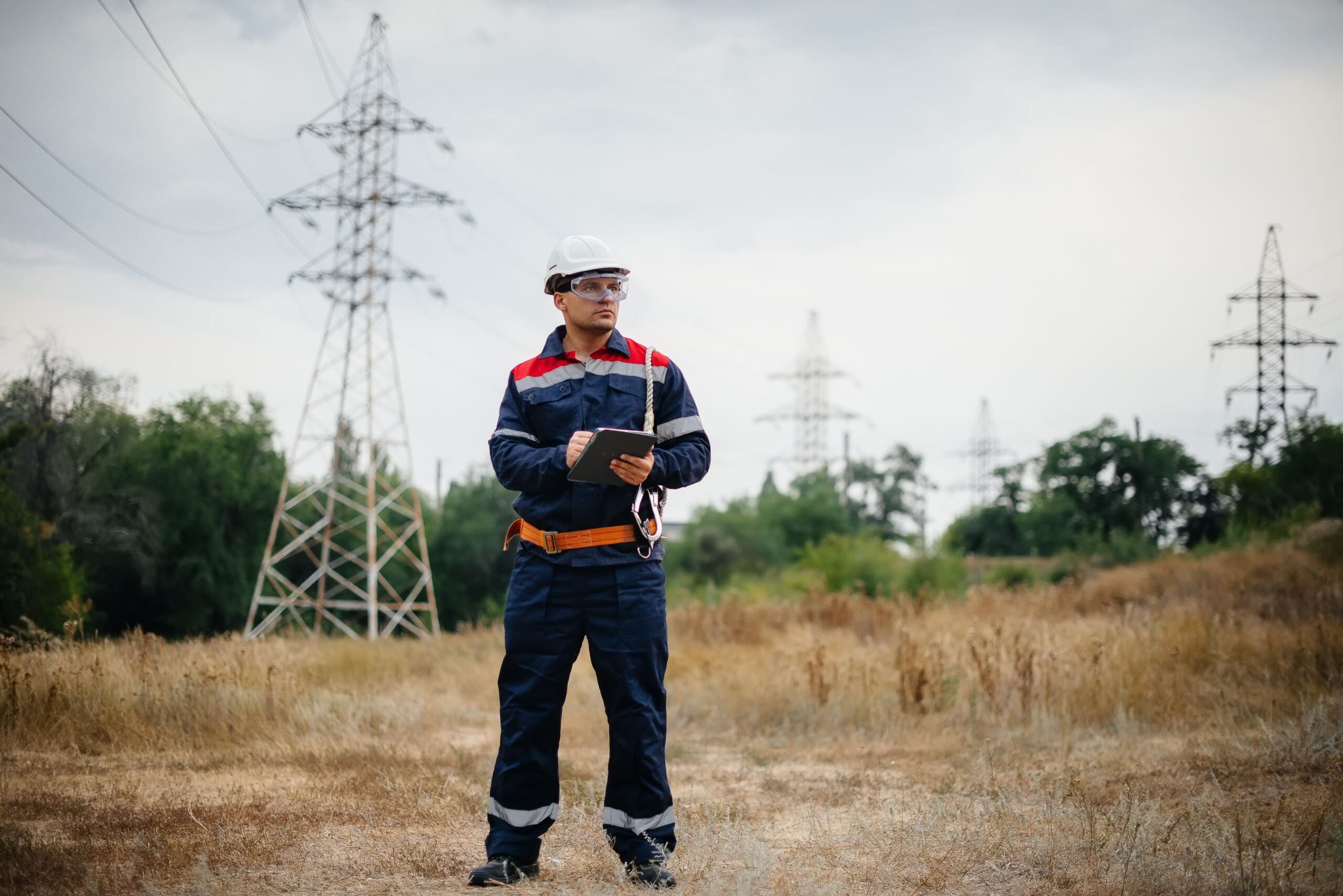 An energy utility field technician inspects power lines with epochfield